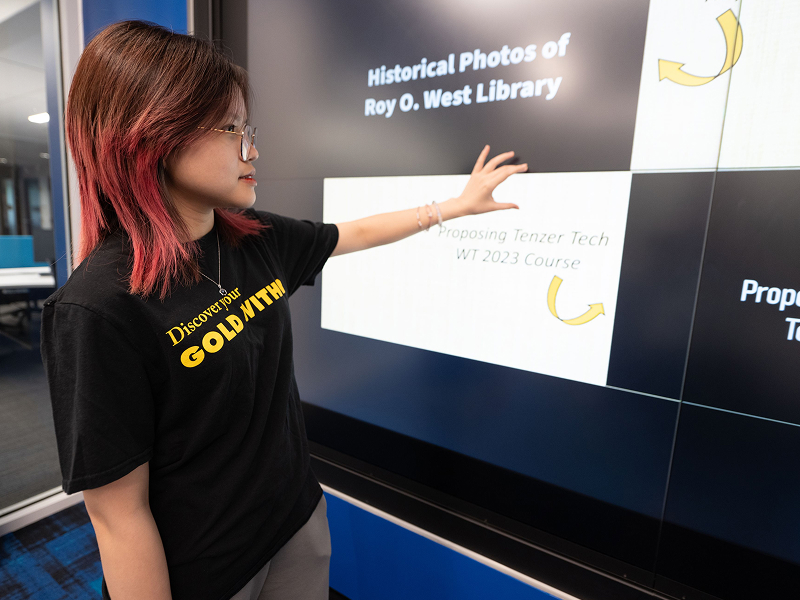 female in front of touch screen