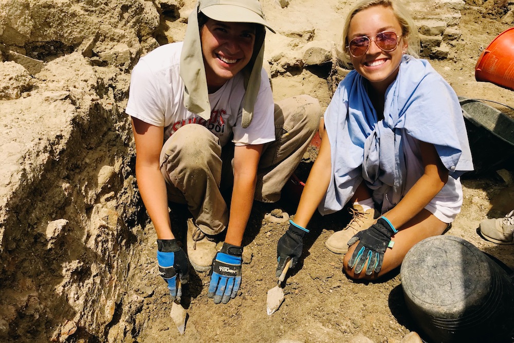 Two students work in a trench at the Trasimeno Archaeology Field School in Umbria, Italy.