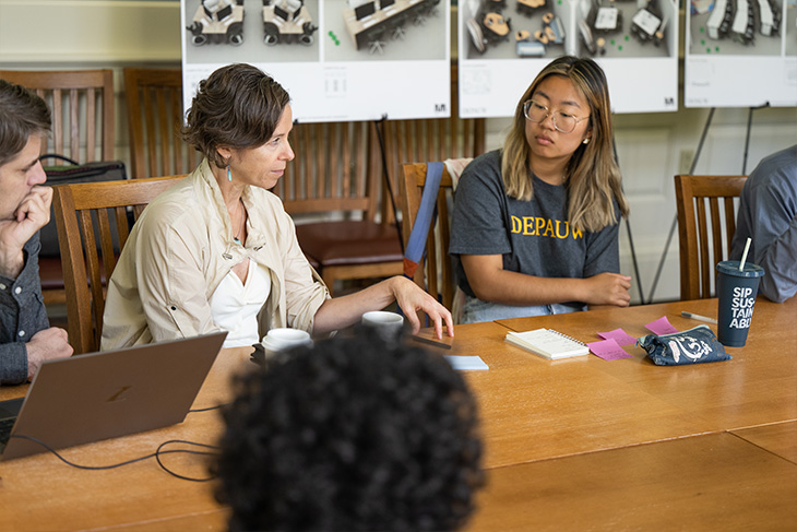 Students and Faculty around a table