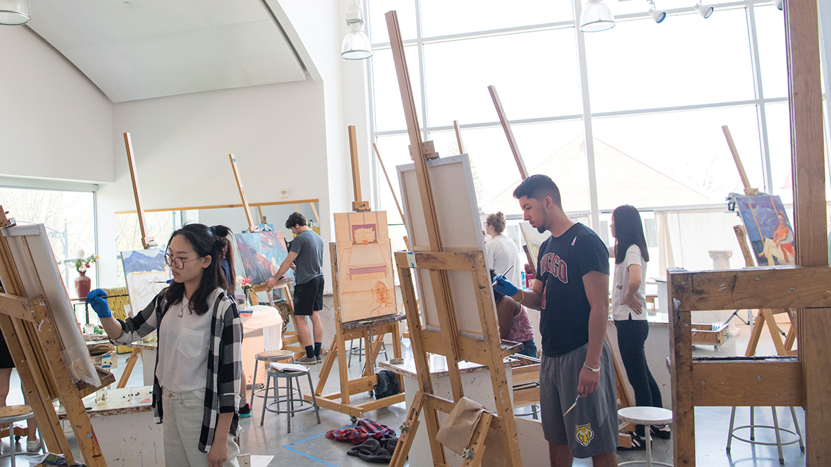 Students painting in an art class