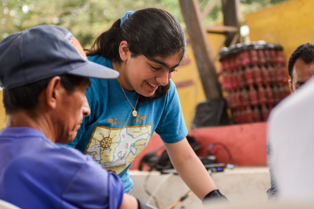 Student assisting a man during a global health trip