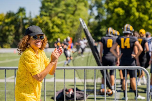 woman with cap clapping