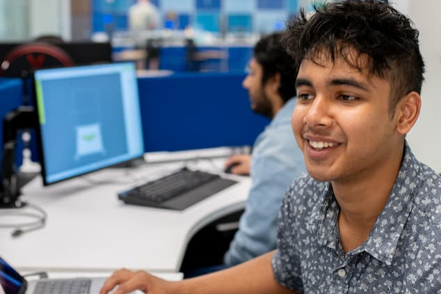 male student in lab with laptops