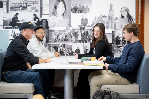 Management Fellows students sitting with advisor in the McDermond Center