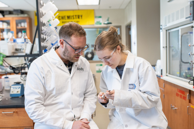 Student and professor conducting research in a science lab