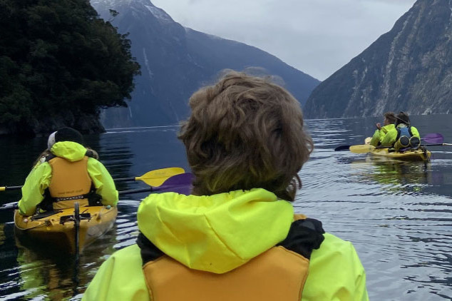 Students kayaking down a river