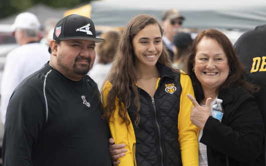 Student and family at old gold tailgate