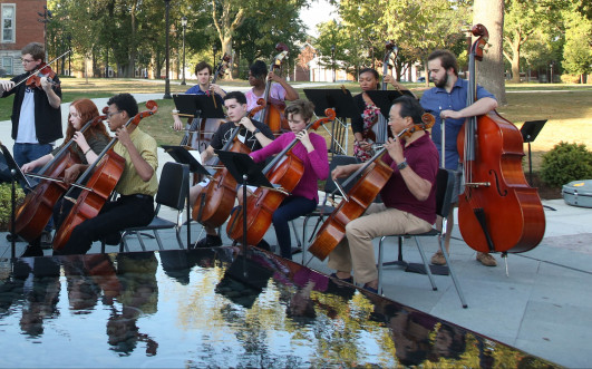 Music students performing with Yo-Yo Ma outside Stewart Plaza