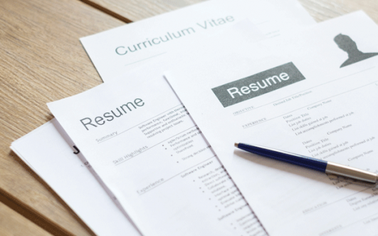 Resumes spread out on a desk