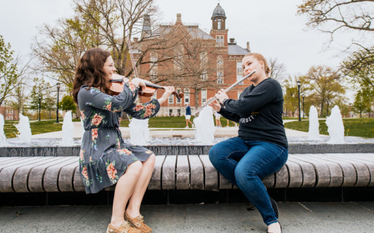 Musicians practicing their craft outdoors on Stewart Plaza on DePauw's campus.