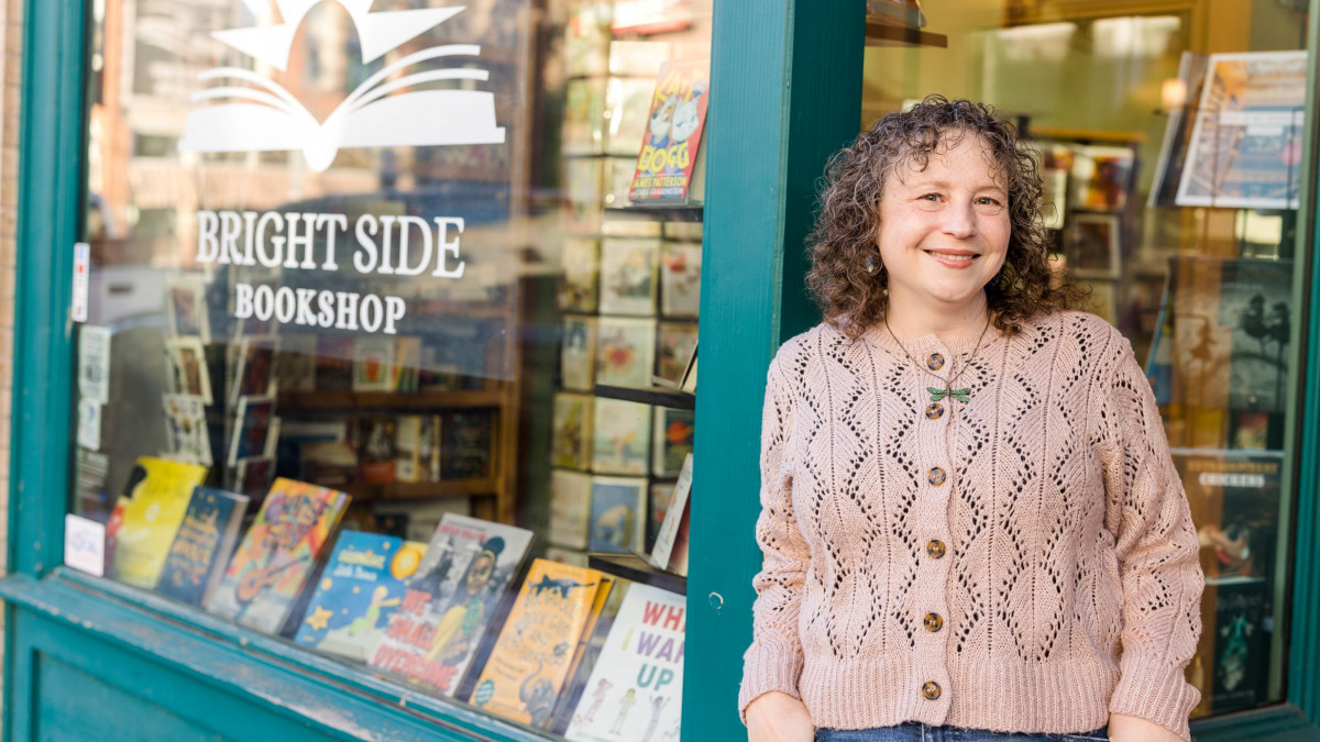 Cori Cusker '95 stands outside the bookstore where she works