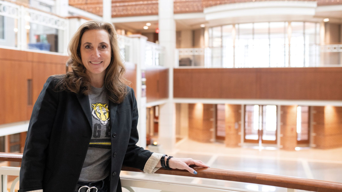 Featured alumnae stands in Julian Science and Mathematics Center