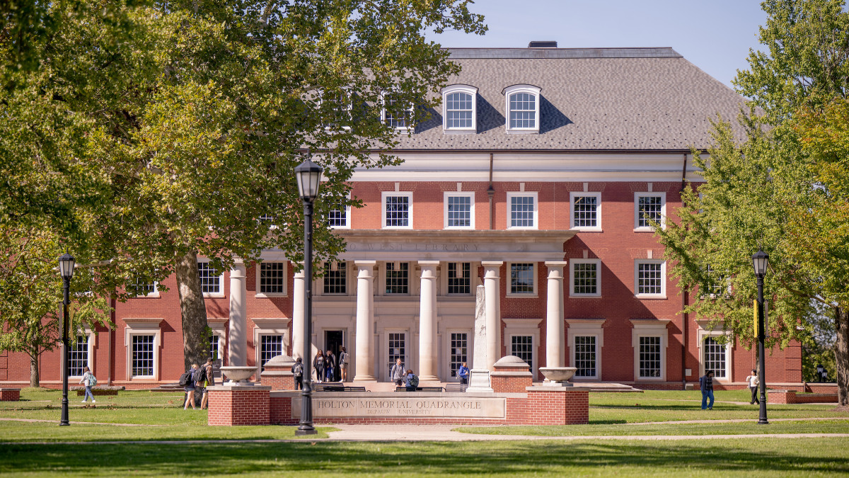 Students walk in front of Roy O. West Library