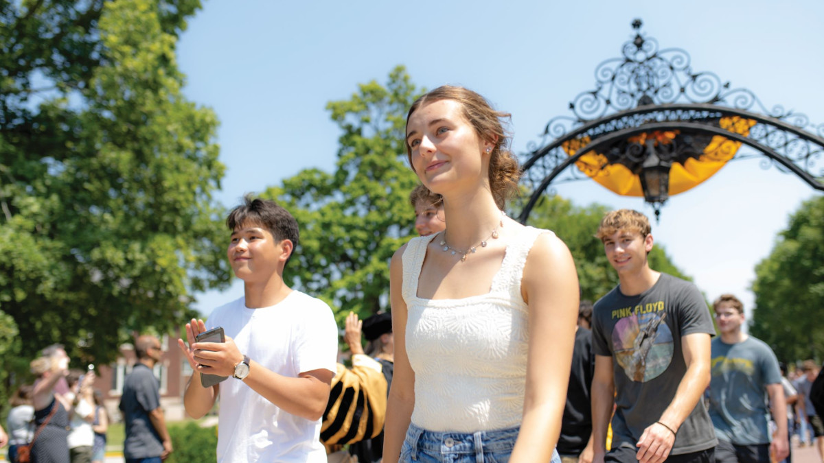 Students walking through the arch