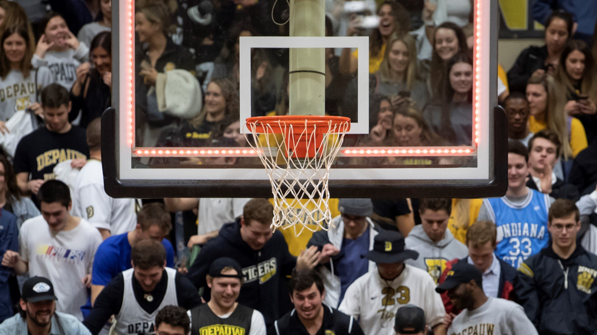 Basketball net with crowd in the back