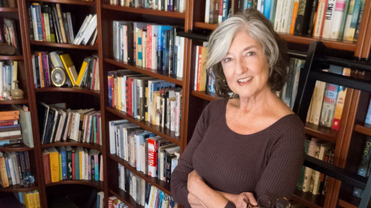 Author Barbara Kingsolver in front of bookshelves