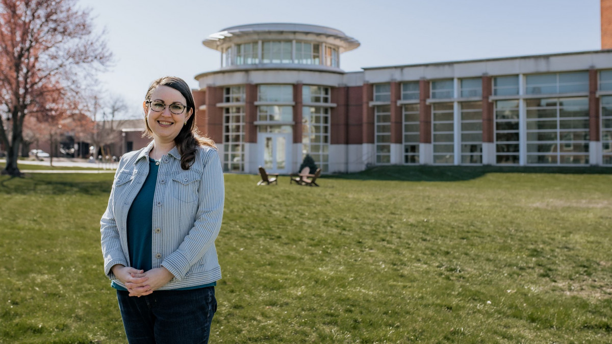 Elissa Harbert stands in front of the Green Performing Arts Center