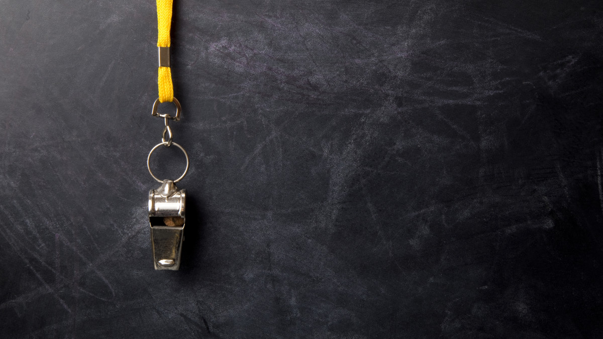 Graphic of a blackboard with a sports whistle hanging in front