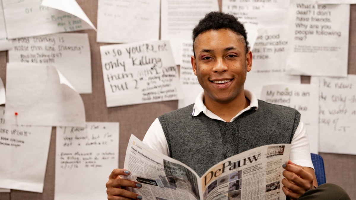 Ian Brundige '22 reads The DePauw in the newsroom. 