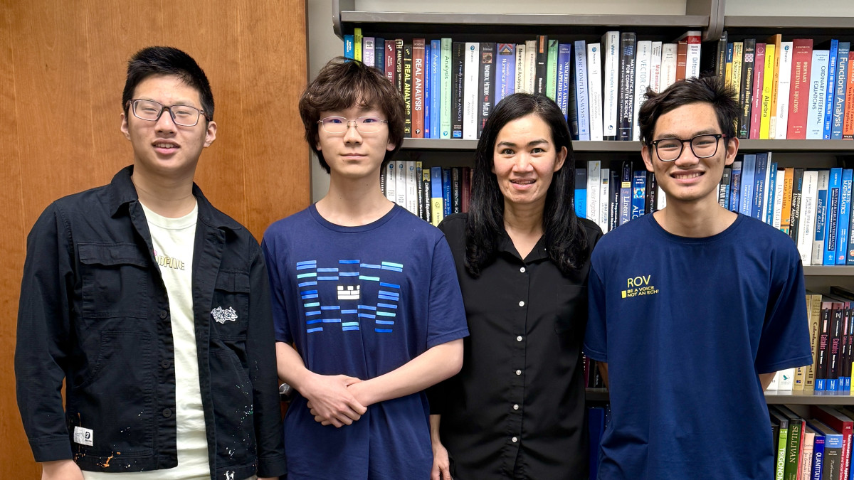 Students from winning math team with professor Sutthirut Charoenphon