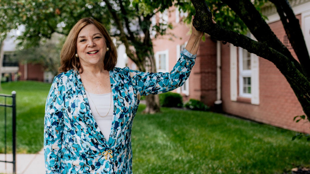 Melissa Martin '71 outside with tree