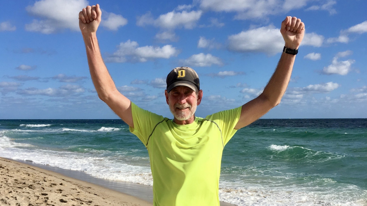 Runner Pat Babington raises his arms in victory