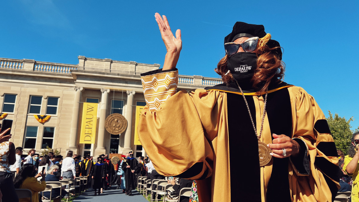 Dr. White, wearing presidential regalia, waves to crowd as she departs inauguration ceremony