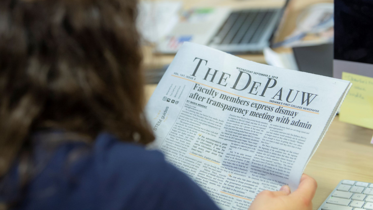Student reads The DePauw, the student newspaper