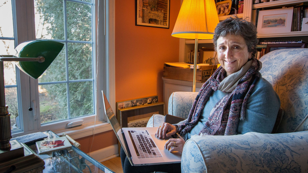 Meg Kissinger types on her laptop in her home office