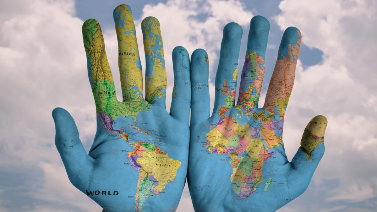 Map of the world painted onto two hands