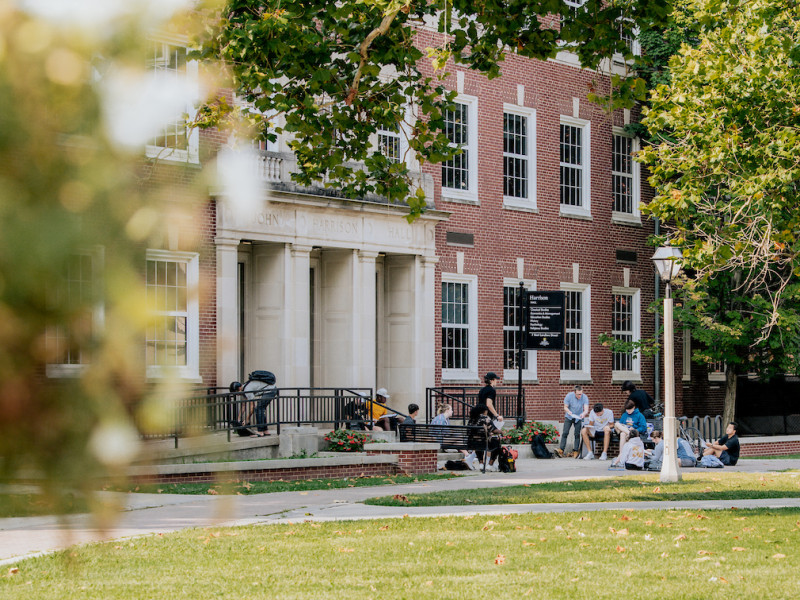 Students relaxing on the lawn outside John Harrison Hall entrance
