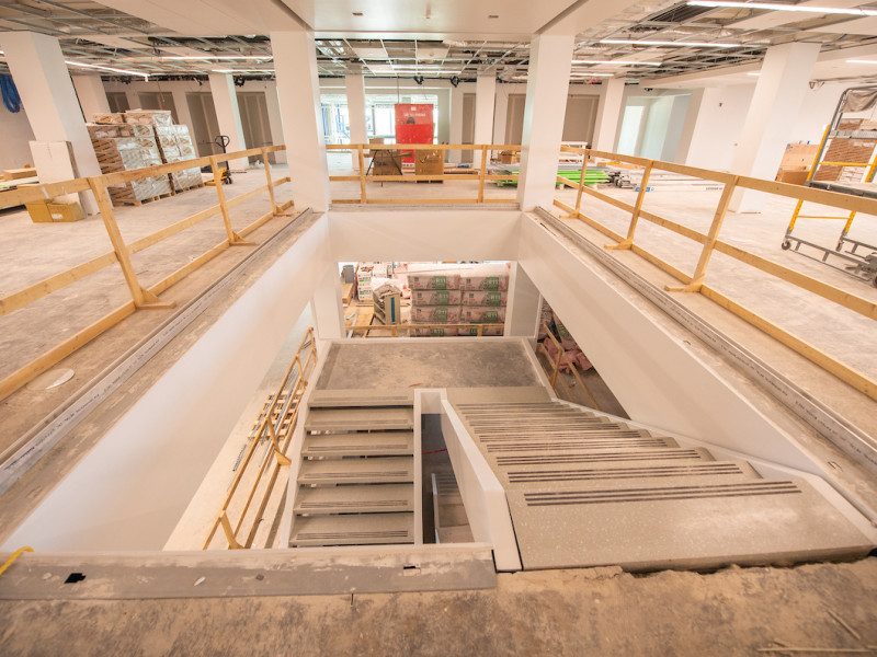 Interior view of concrete staircase under library renovation construction