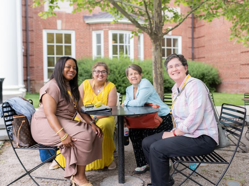 Four females sitting outside at a table