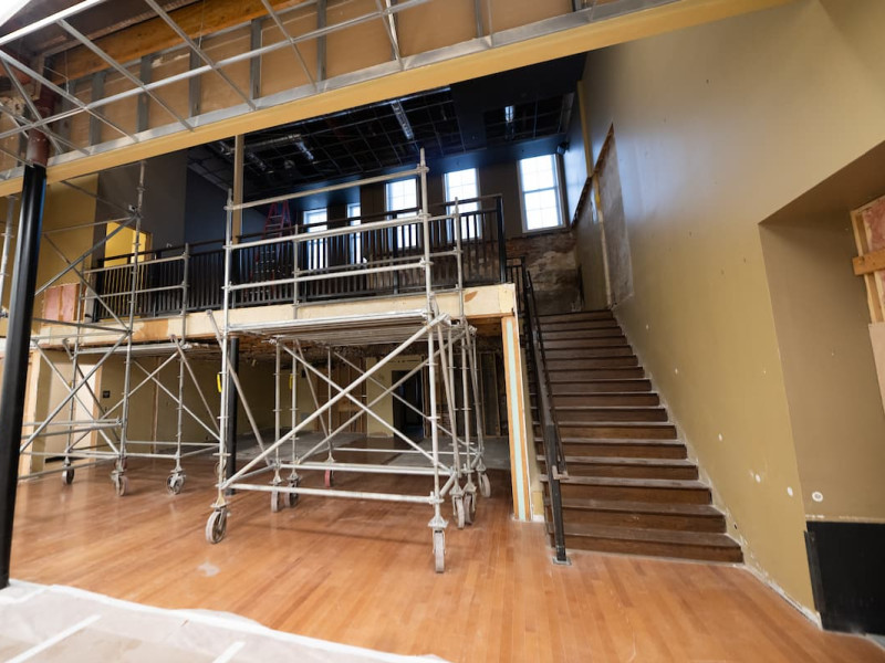 Theater renovation interior showing scaffolding, stairs, and balcony