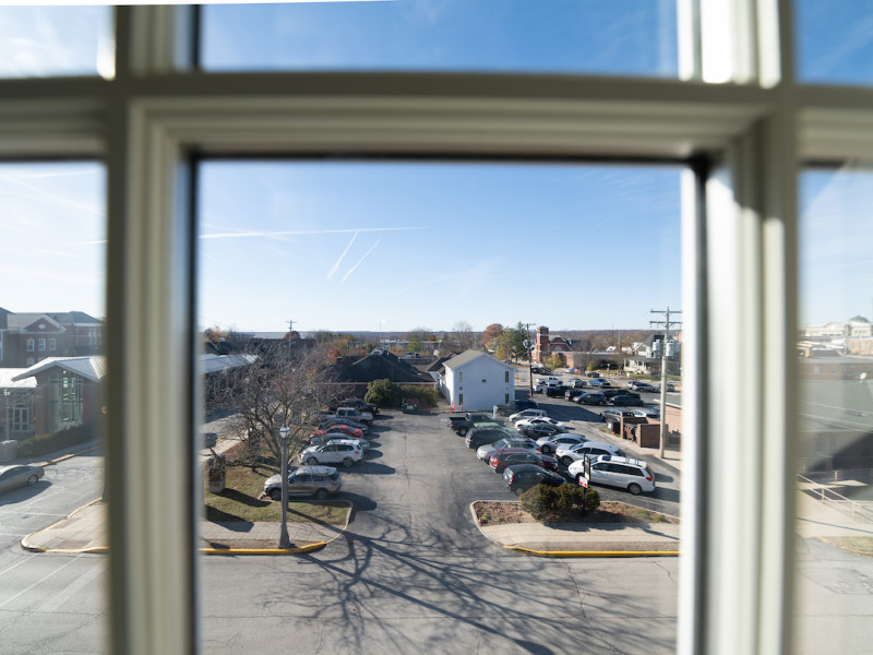 View of a parking lot from a window frame