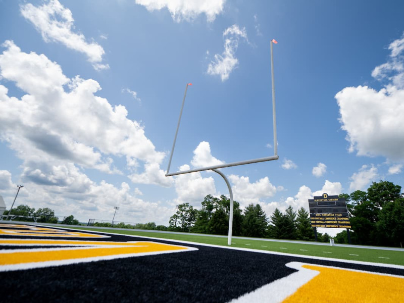 Low view of goalpost and scoreboard on football field