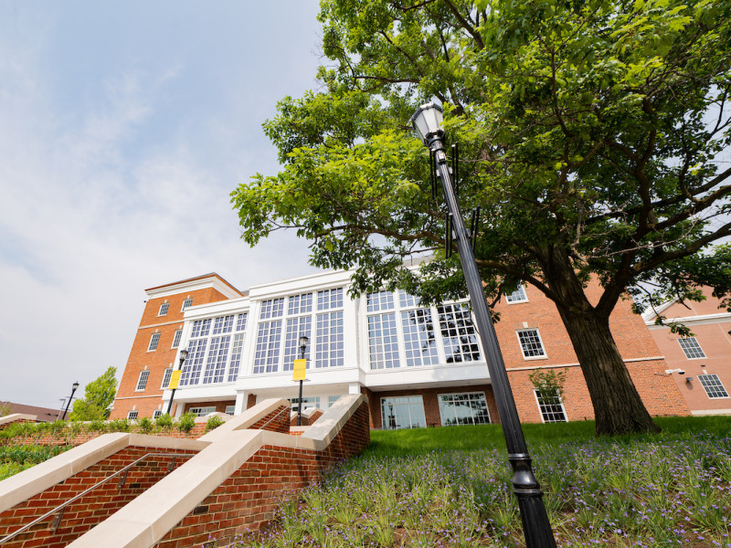 Exterior of a large brick building with modern glass facade