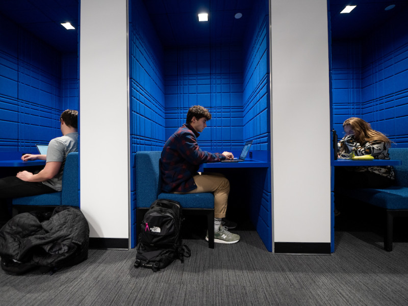 Three students studying in blue acoustic privacy booths