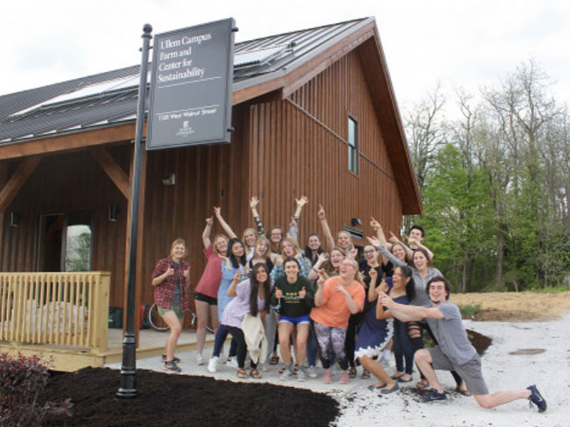 Students posing in front of Ullen Campus Farm