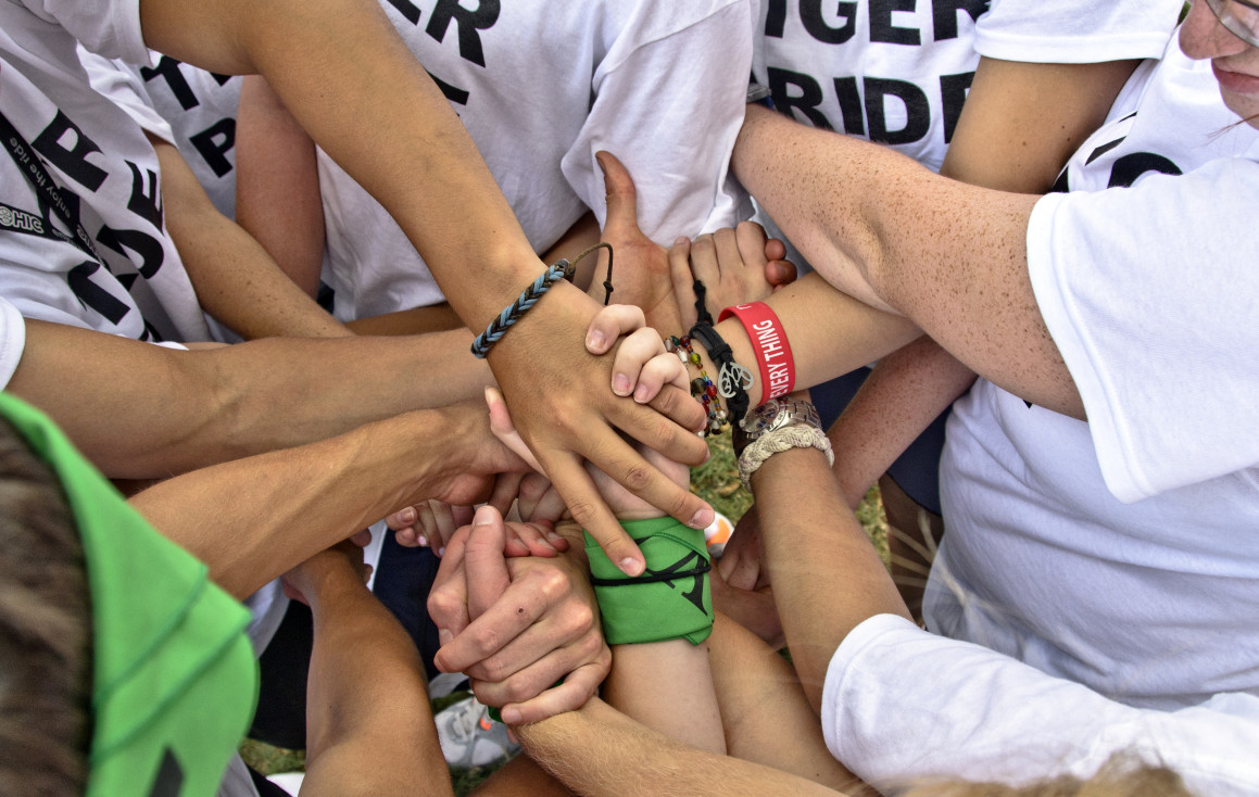 A group of people holding each other's hands.