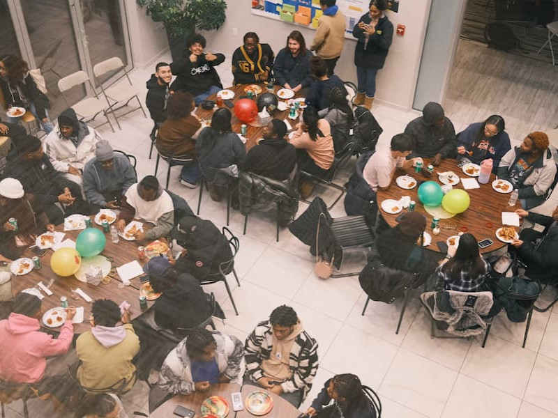 Students eating and socializing at a Black History Month event