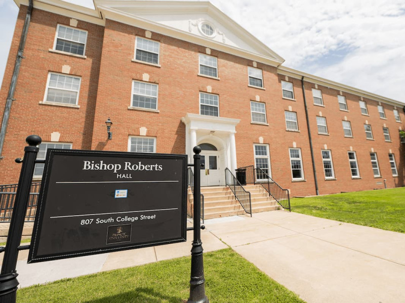 Exterior of Bishop Roberts Hall residential building and sign