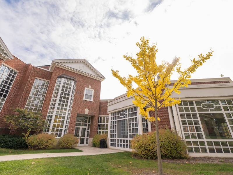 Exterior of a brick campus building during autumn.