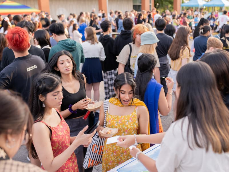 Students interacting at an outdoor campus block party