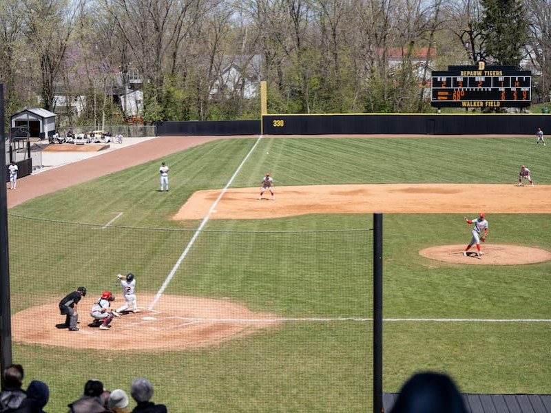 Pitcher throwing to a batter during a campus baseball game
