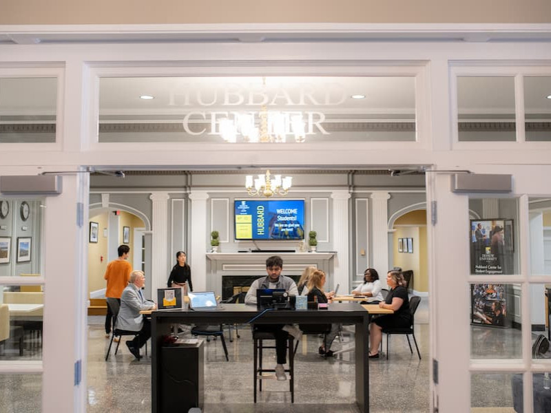 Students and staff working in the Hubbard Center lobby