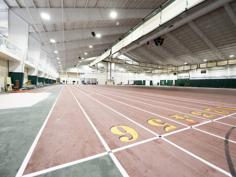 Interior view of an empty university indoor track facility