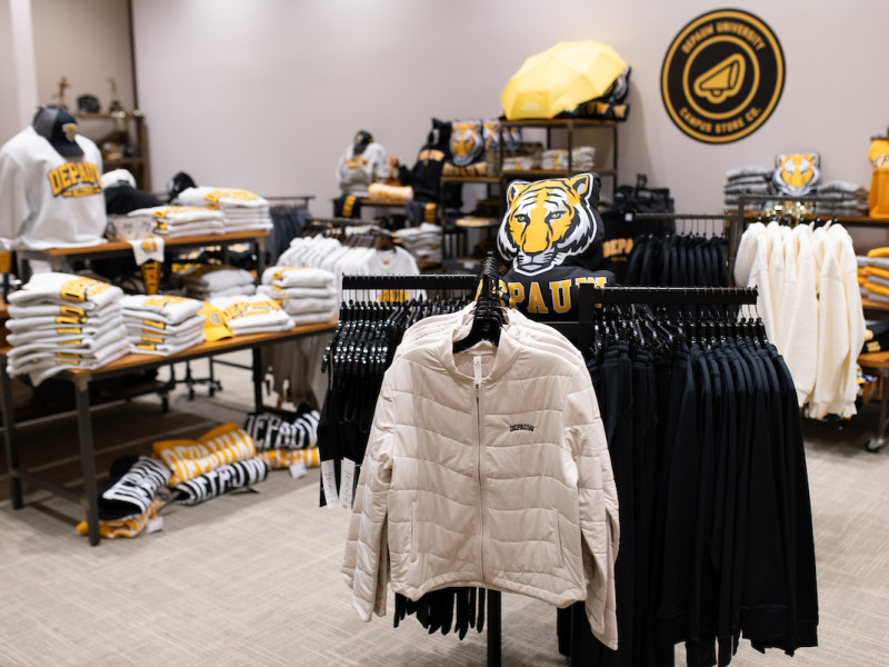 Racks of university apparel inside a campus bookstore