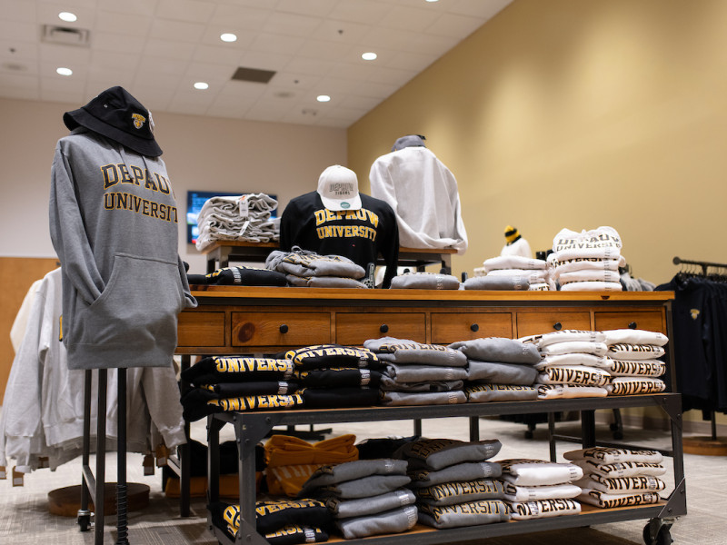 University hoodies and hats on display in a bookstore
