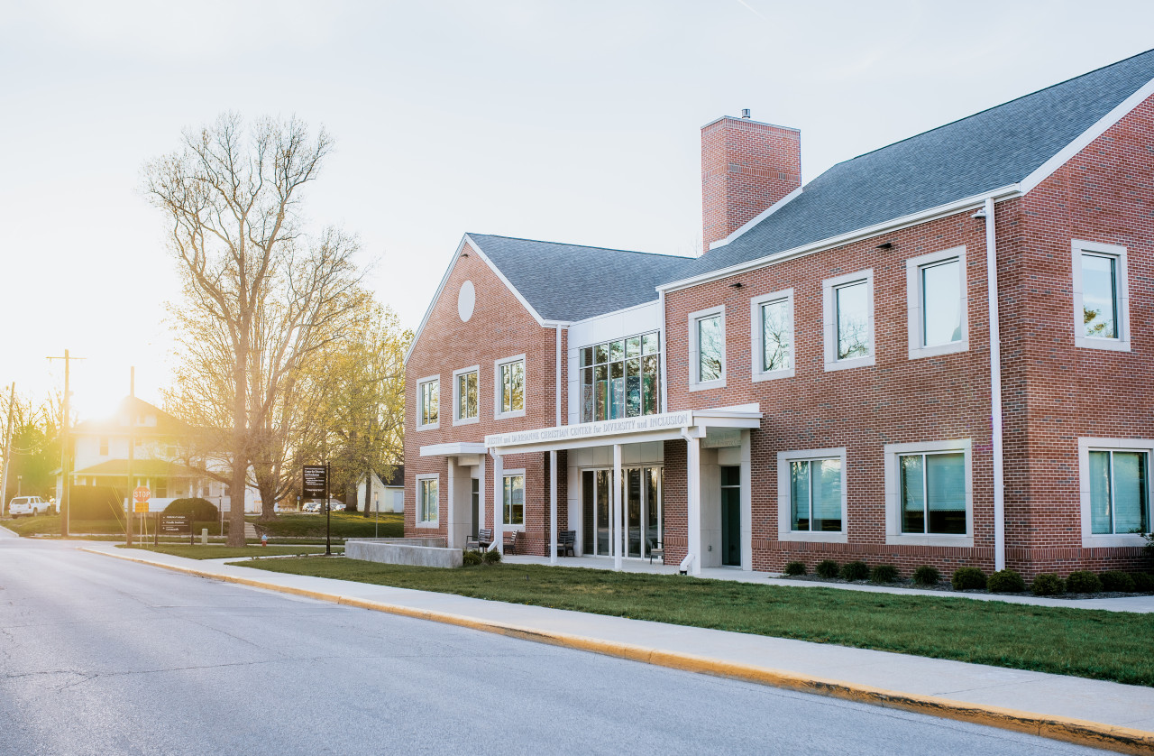 Exterior of the Justin and Darrianne Christian Center for Diversity and Inclusion building at sunset.